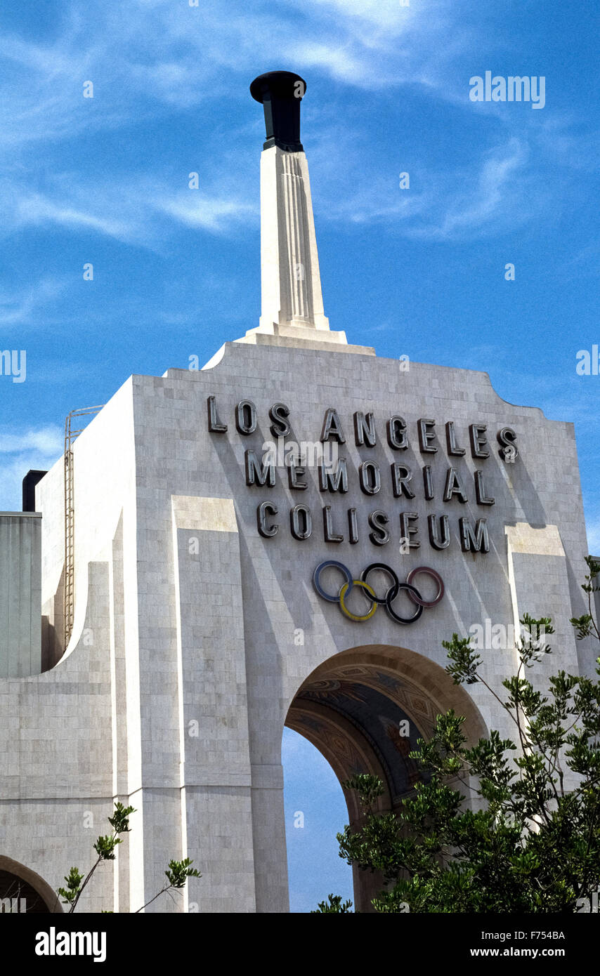 The Los Angeles Memorial Coliseum is a venerable outdoor sports stadium in Southern California, USA, that was host to the Summer Olympic Games in 1932 and 1984. Ever since opening in 1923 it has been the home stadium of the USC Trojans, the football team of the University of Southern California. The impressive main entrance into the LA Coliseum is an archway displaying the Olympic symbol of five interlinked rings and the Olympic torch that is ignited for special events. The stadium can hold more than 93,000 spectators and has been proposed to host the Summer Olympics again in 2024. Stock Photo