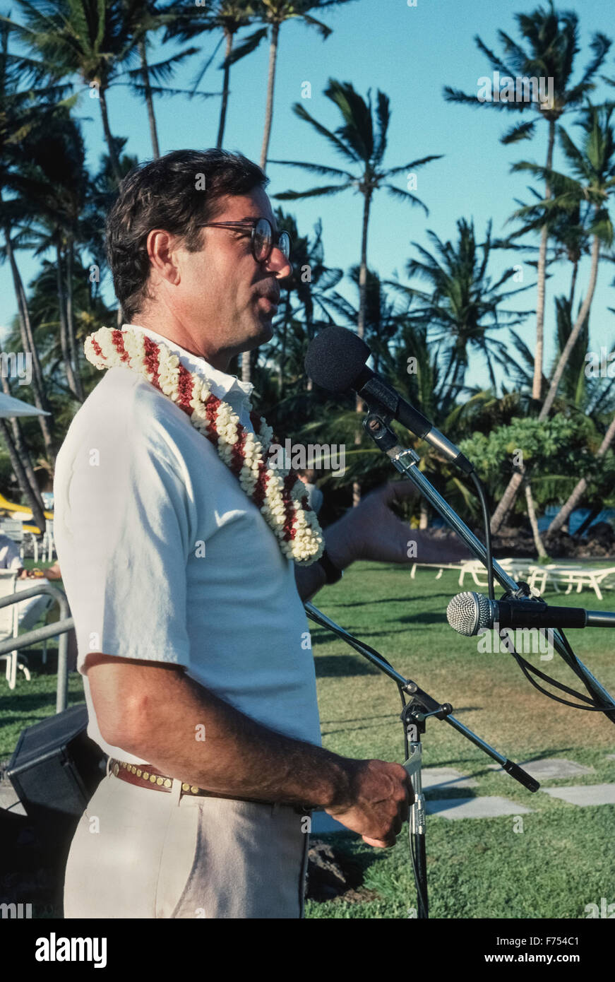 In 1989 at the age of 48, American travel writer and novelist Paul Theroux recalls his adventurous life while giving a talk outdoors in Honolulu, Hawaii, USA. He gained literary fame in 1975 following publication of 'The Great Railway Bazaar' that was based on his trip by train from England to Japan. Next came 'The Old Patagonian Express,' a travel book about his rail journey from Boston, Massachusetts, to Argentina. Theroux also received much praise for 'The Mosquito Coast,' an adventure novel that was made into a movie in 1986. Stock Photo