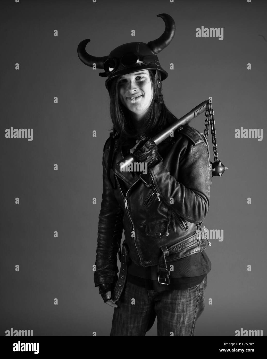 Weird costume player, horned helmet and ball and chain club Stock Photo