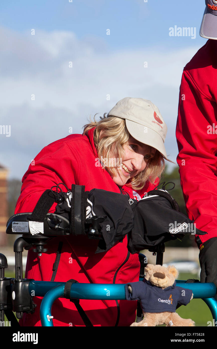 Great Yarmouth, UK. 25th November 2015. Great Yarmouth woman Lisa Borrett, who has cerebral palsy, defeats medical sceptics by learning to walk after a life in a wheelchair. Completing the longest walk of her life and her first outdoors to raise money for local charity Centre 81 and her own enterprise Life Takes Two, 34 year old Lisa even manages a lap of honour around the quarter mile athletics track at the Wellesley recreation Ground in Great Yarmouth. Credit:  Adrian Buck/Alamy Live News Stock Photo