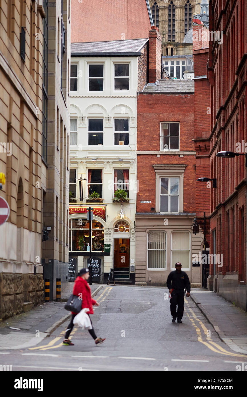 Manchester Town Hall clock tower frames the scene of Tib Lane with the