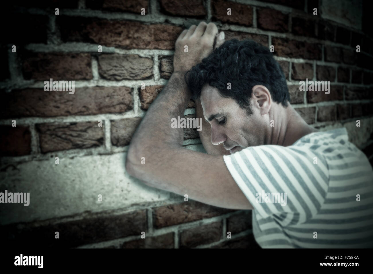 Man leaning on wall with hand hi-res stock photography and images - Alamy