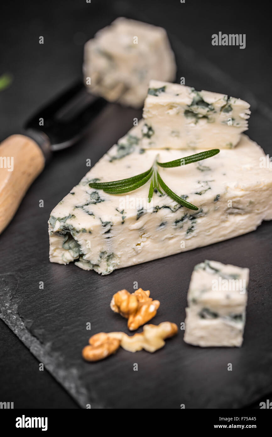 Blue cheese with nuts on black slate Stock Photo Alamy