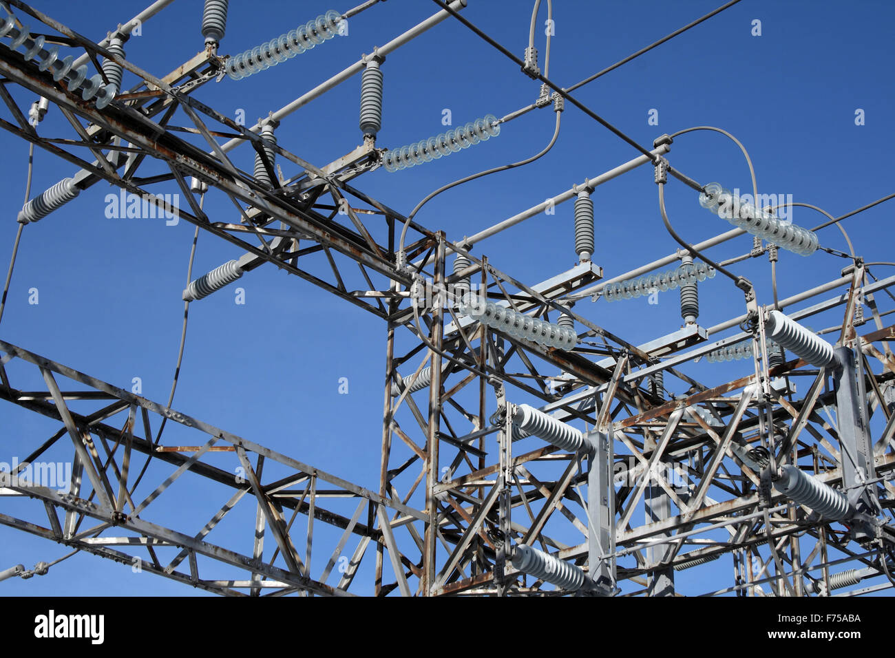 Insulators of high voltage electricity plant Stock Photo - Alamy