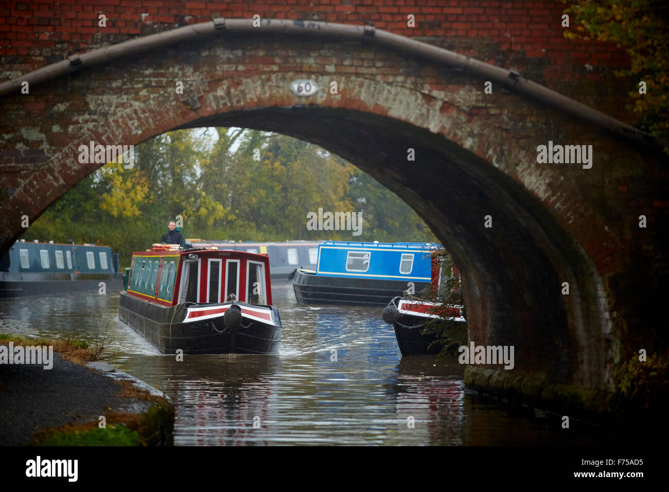 Alvechurch in  Worcestershire marina waterway boat yard mist blue canal autumn moving through arch bridge under      UK Great Br Stock Photo