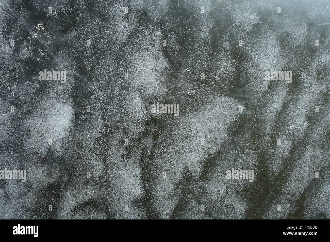 Frozen air bubbles in ice Stock Photo
