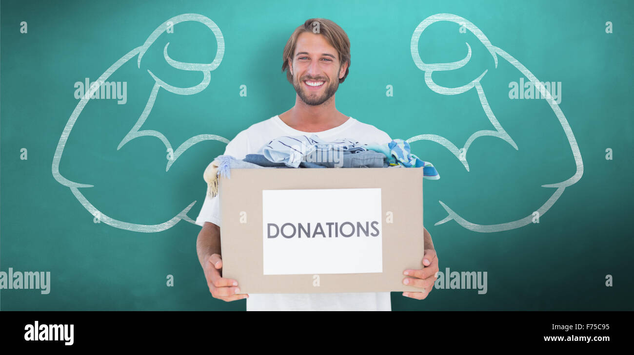 Composite image of happy man carrying donation box Stock Photo