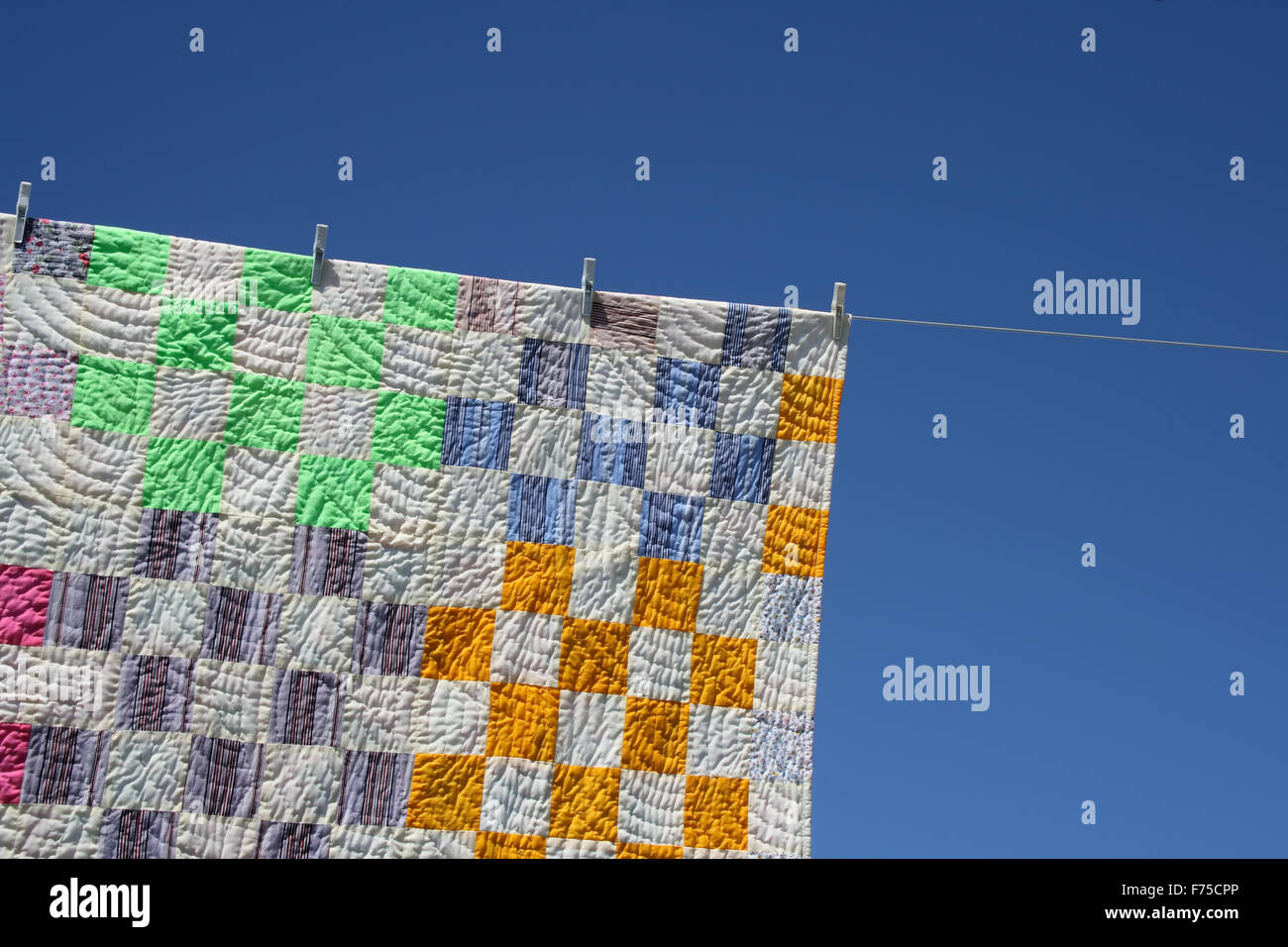 Patchwork counterpane on a clothes-line Stock Photo