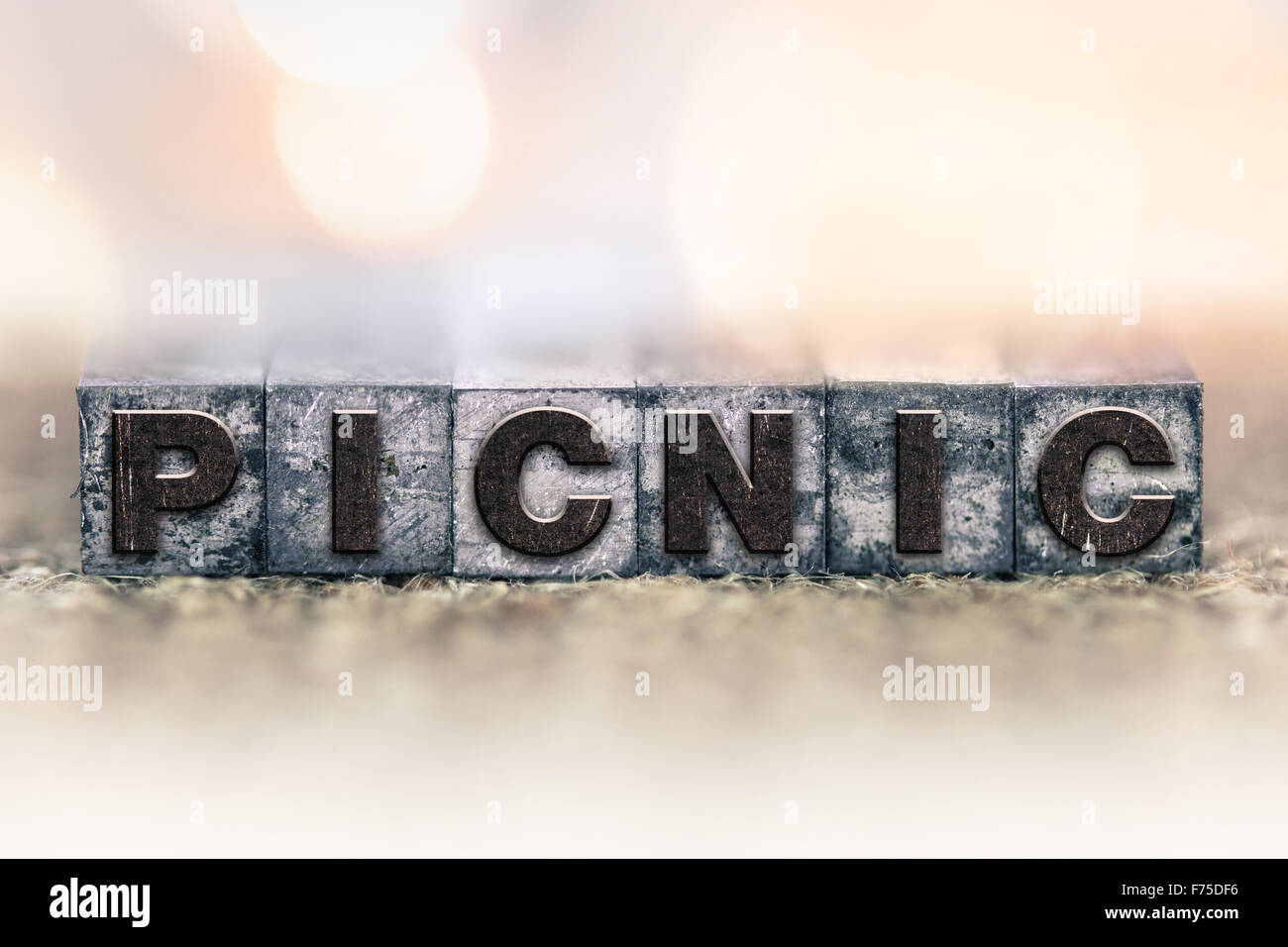 The word "PICNIC" written in vintage ink stained letterpress type Stock