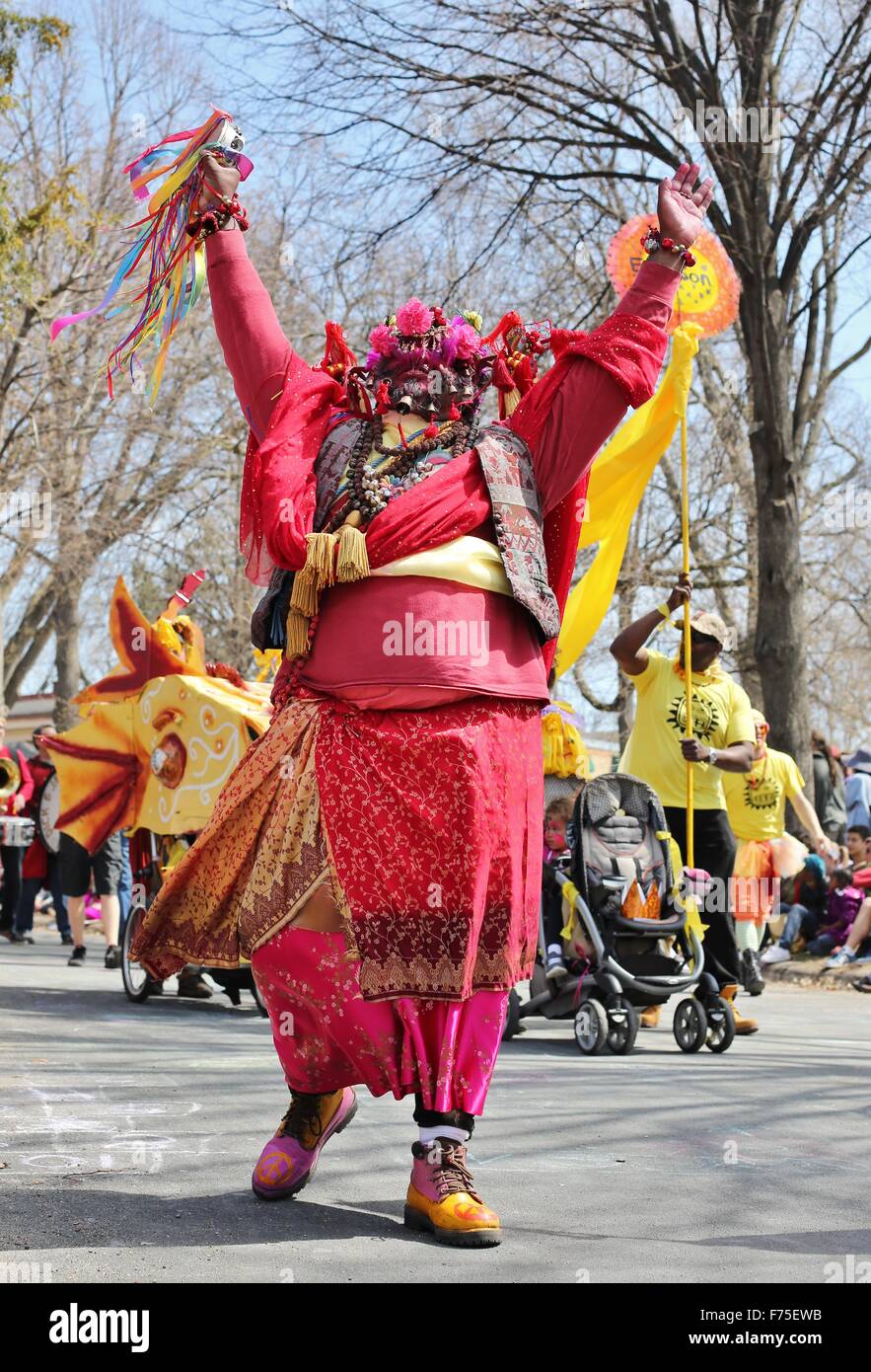 A man dressed in a colorful costume at the May Day parade in