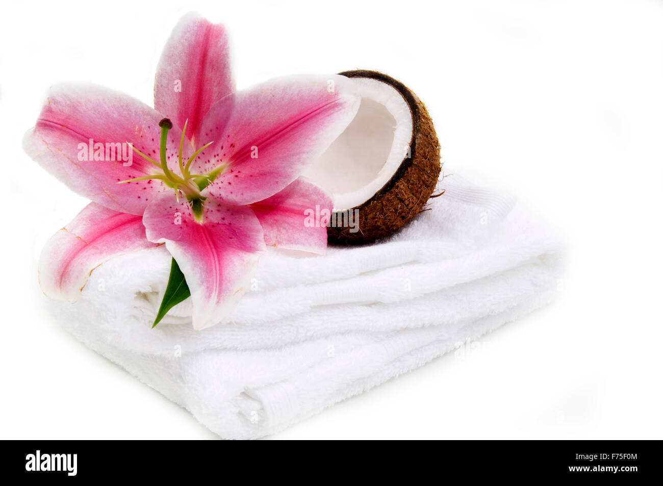 Coconut, lilly flower and white towel Stock Photo