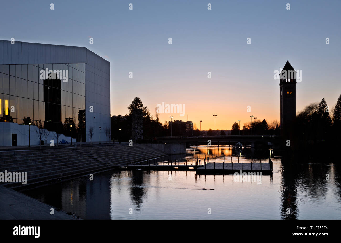 The Spokane Clock Tower reflecting at sunset in the glass windows of the Convention Center located in Riverside Park, Spokane. Stock Photo