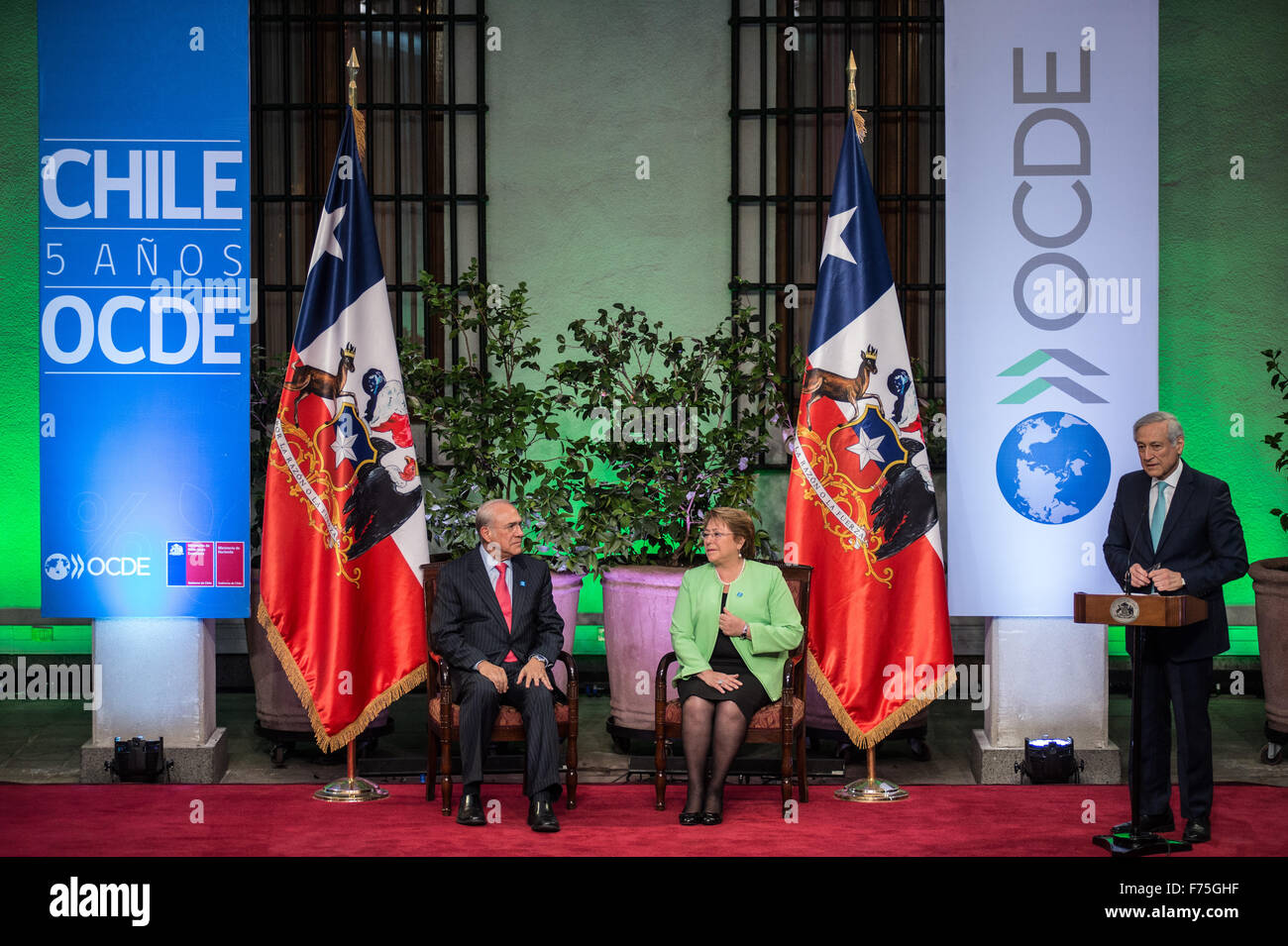 Santiago, Chile. 25th Nov, 2015. Chile's Foreign Minister Heraldo Munoz(R) delivers a speech in presence of Chilean President Michelle Bachelet (C) and the Secretary General of the Organzation for Economic Cooperation and Development (OECD) Jose Angel Gurria during a ceremony at La Moneda Palace in Santiago, capital of Chile, on Nov. 25, 2015. © Jorge Villegas/Xinhua/Alamy Live News Stock Photo
