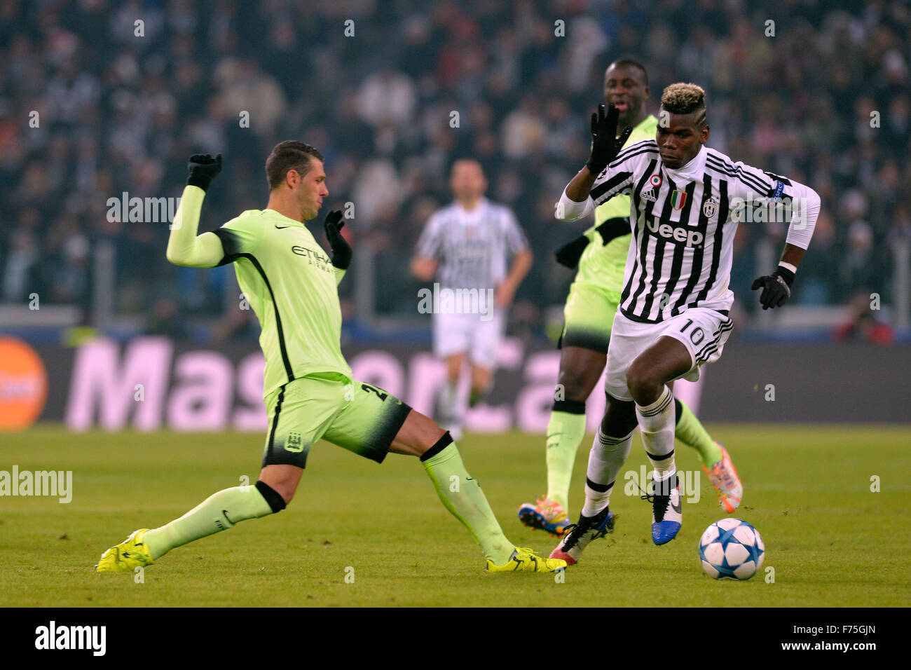 Turin, Italy. 25th Nov, 2015. Champions League. Juventus versus Manchester City. Paul Pogba avoids the tackle from Martin Demichelis Credit:  Action Plus Sports/Alamy Live News Stock Photo