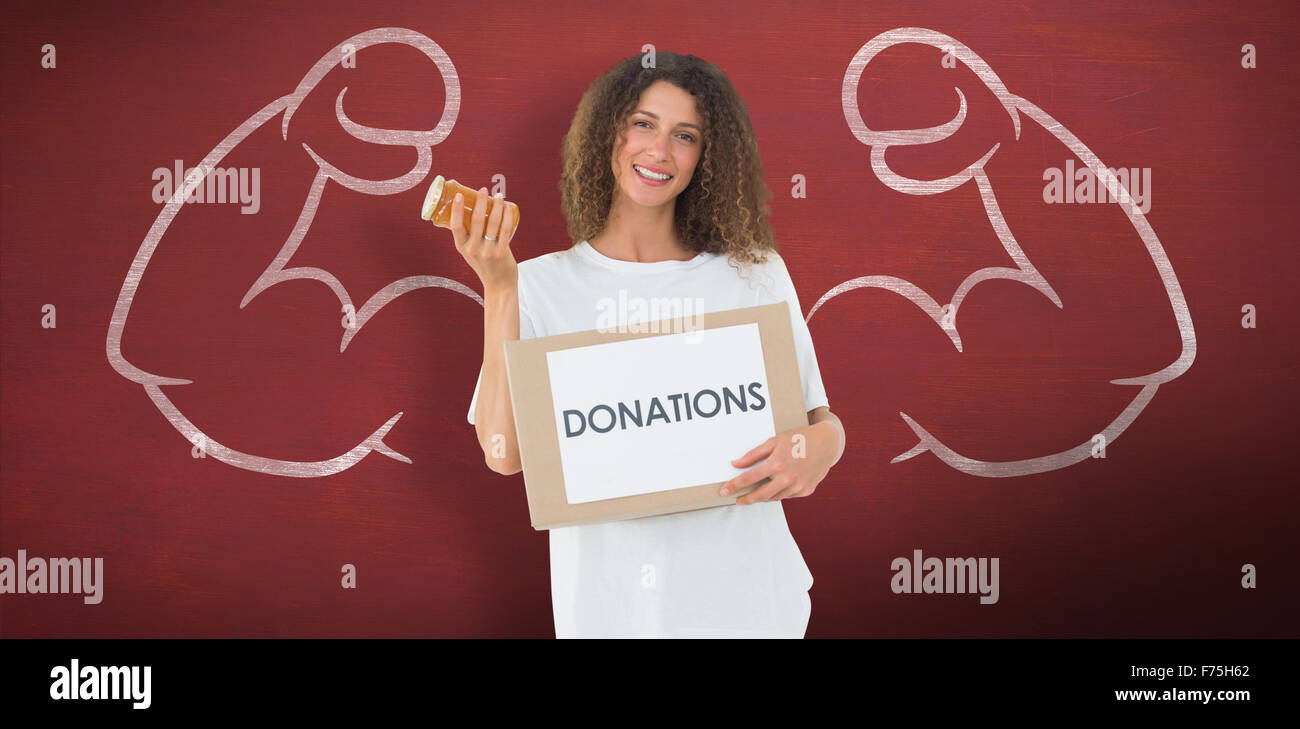 Composite image of happy volunteer holding a box of donations and jam jar Stock Photo