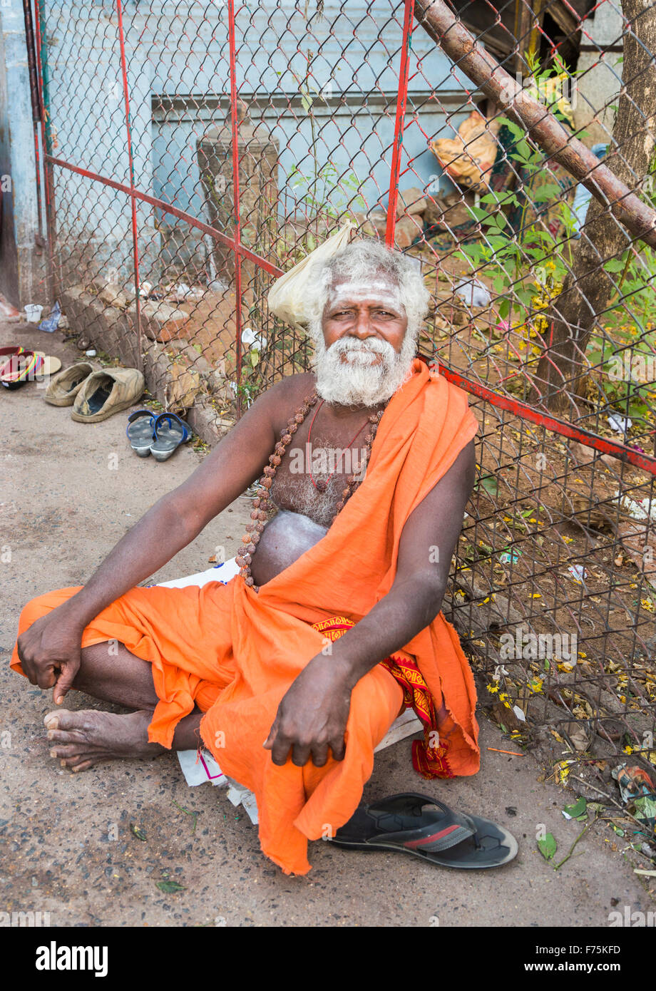 Old man devotee dressed wearing saffron robe sitting outside the  Kapaleeswarar Temple, a Hindu temple of Shiva, Mylapore, Chennai, Tamil  Nadu, India Stock Photo - Alamy