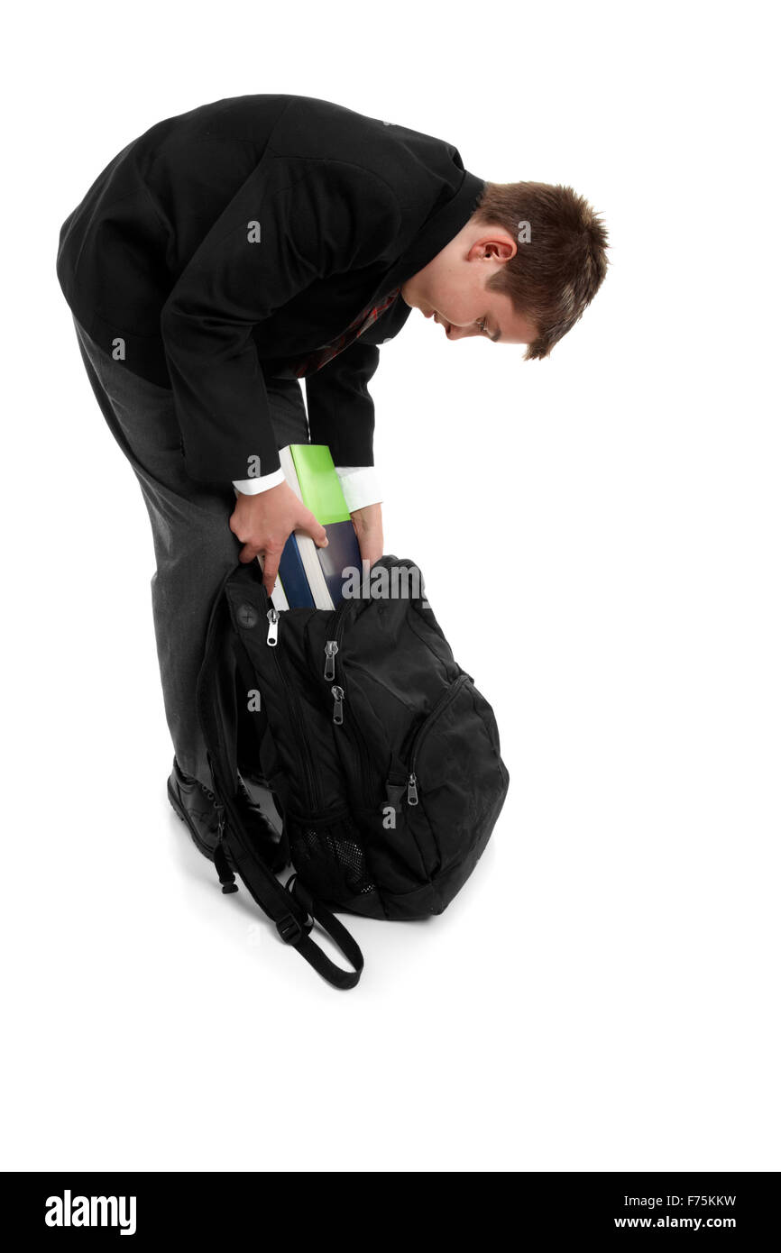 School boy packing school bag Stock Photo