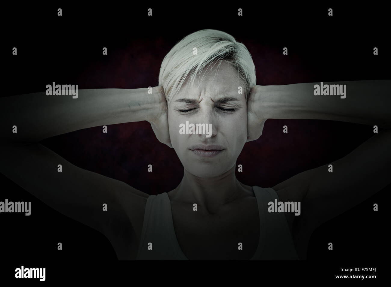 Composite image of upset woman covering her ears Stock Photo Alamy