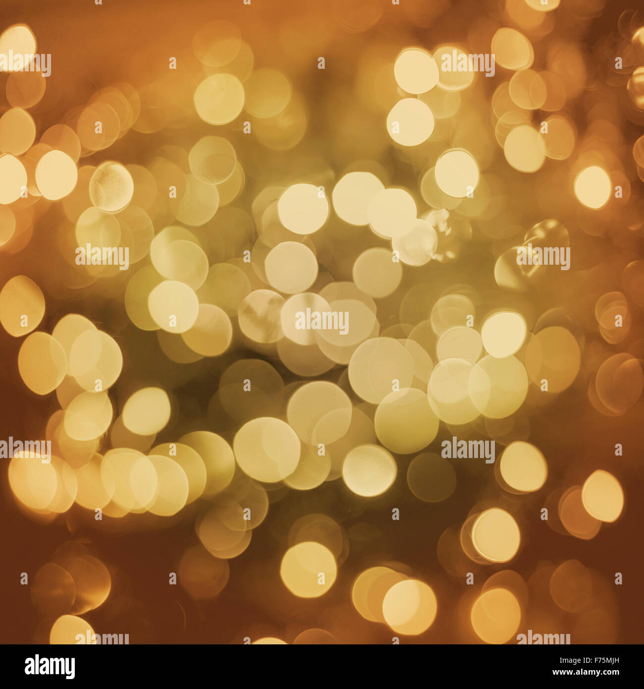 Gold sparkle blur light elegant retro background. Ideal for holiday greeting card, event or party invitation. Stock Photo