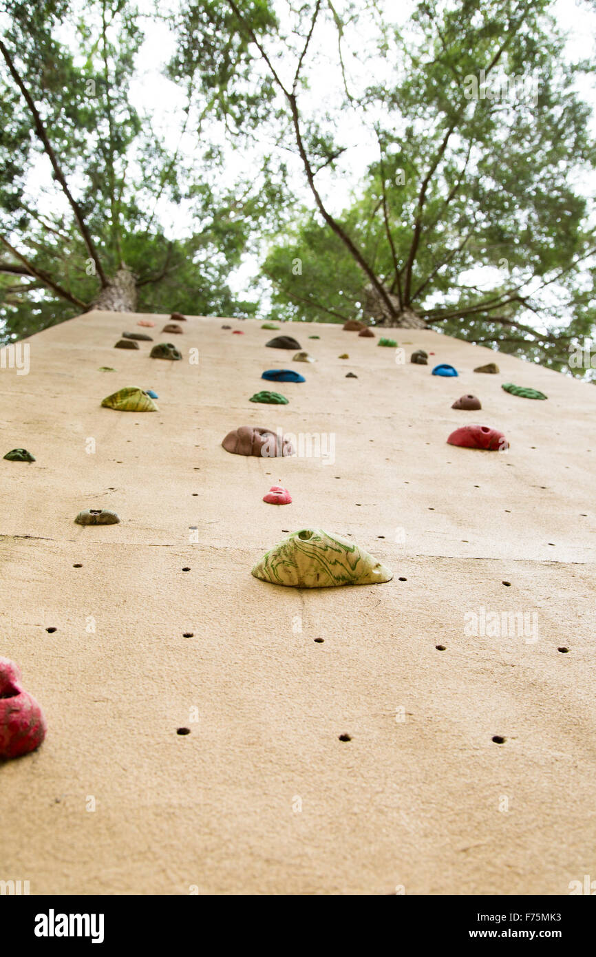 view from the ground looking up at an outdoor climbing wall.  Implies concept of facing challenge and heading upwards Stock Photo