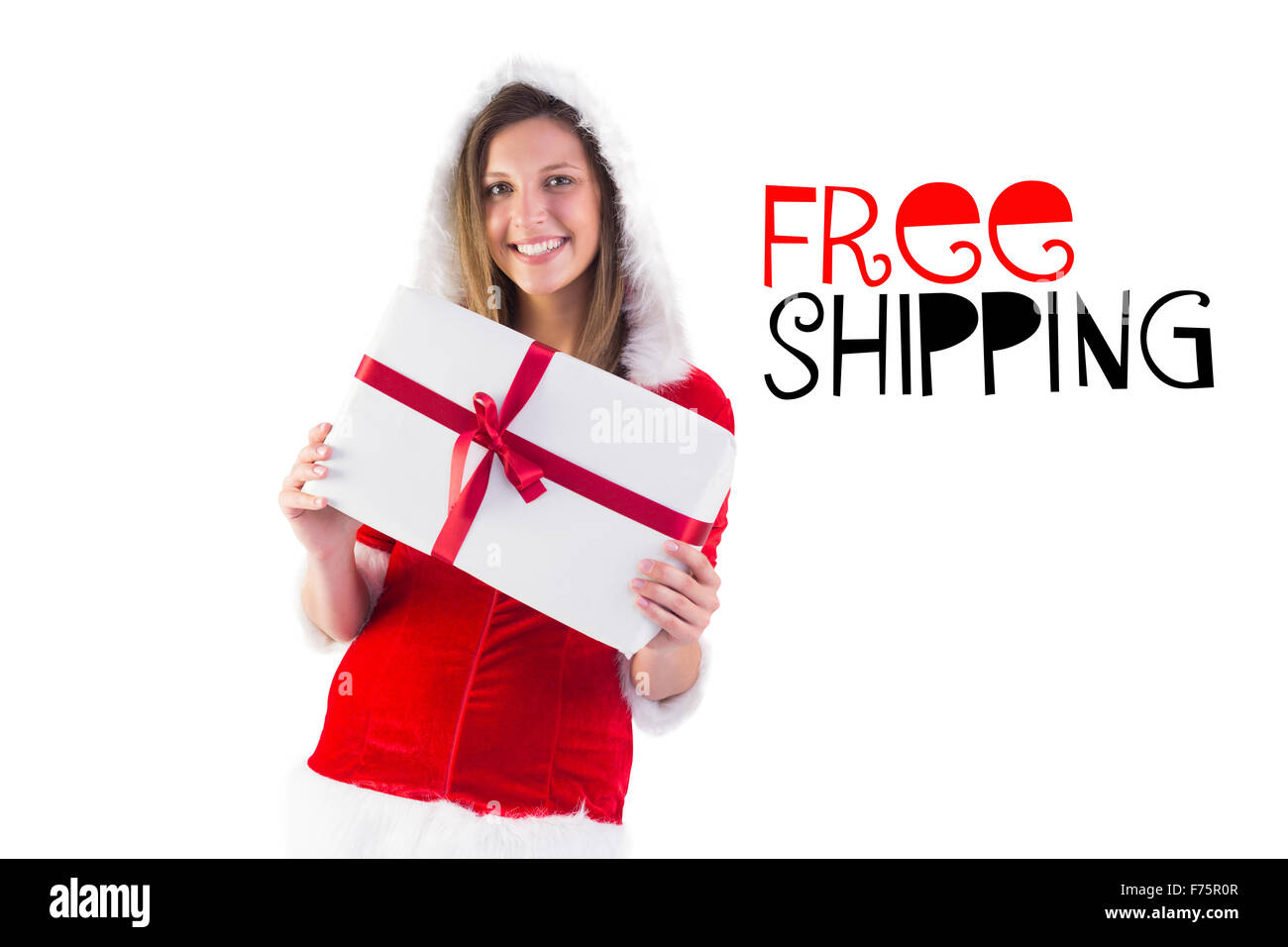 Composite image of pretty santa girl holding gift Stock Photo - Alamy