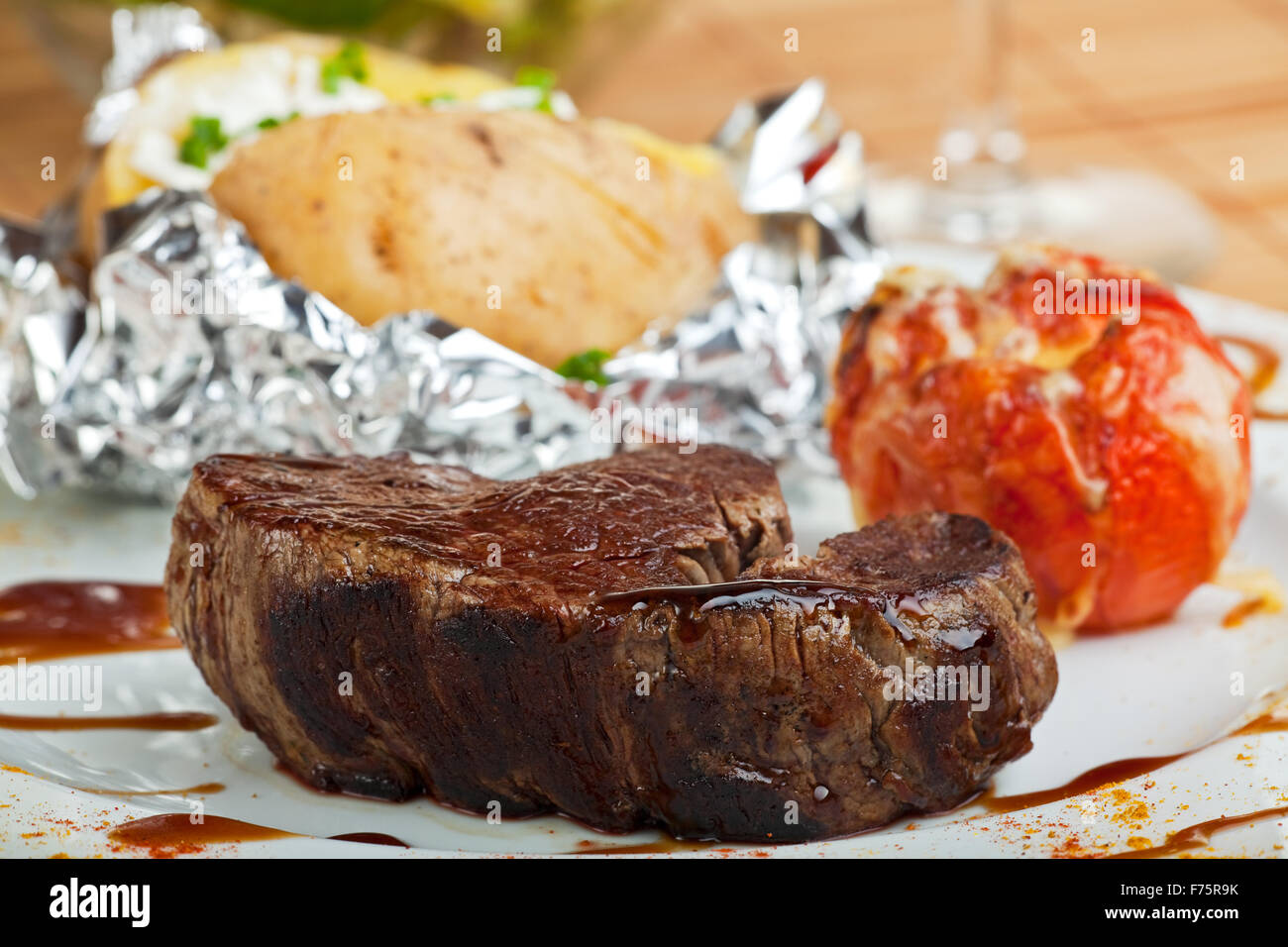 grilled steak with baked potato Stock Photo - Alamy