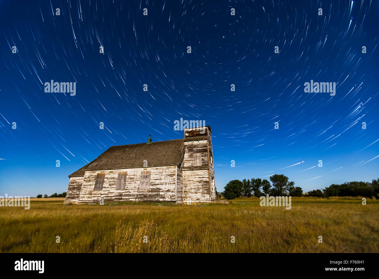 Circumpolar star trails over the historic but sadly neglected St. Anthony’s Church between Bow Island and Etzikom, Alberta. The Stock Photo