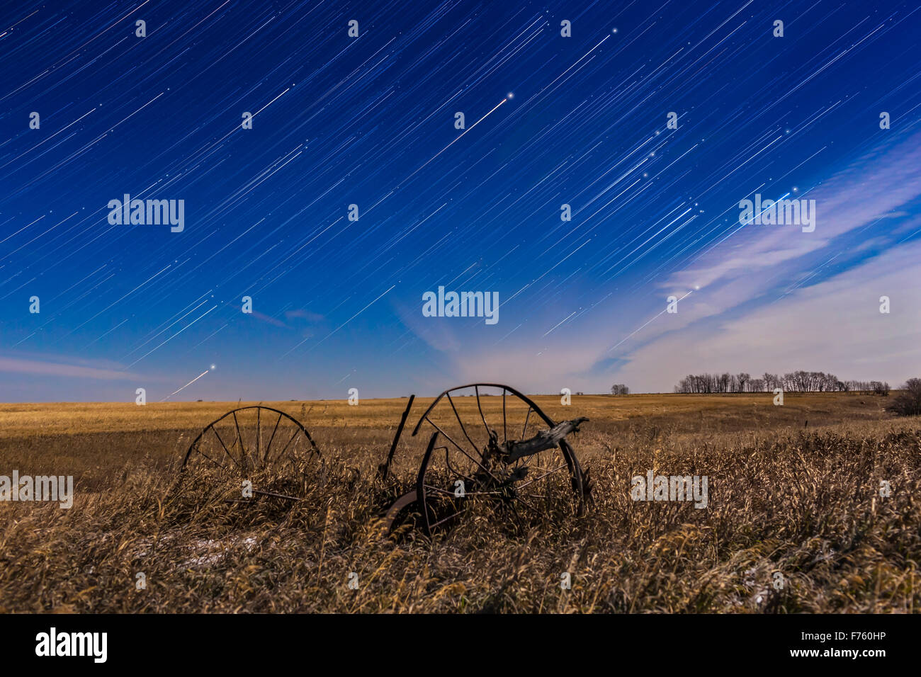 Orion, at right, rising in star trails behind the old plough, at home, on a bright moonlit night in November, with light from a Stock Photo