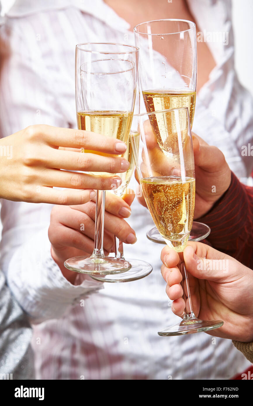 Hands of toasting friends holding flutes with champagne Stock Photo - Alamy