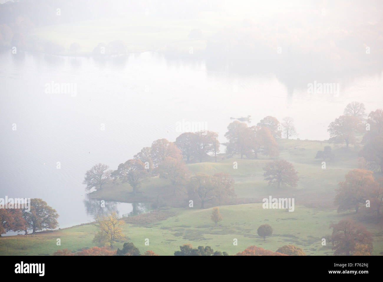 Looking down on Lake Windermere in the Lake District in poor visability due to thin fog. Stock Photo