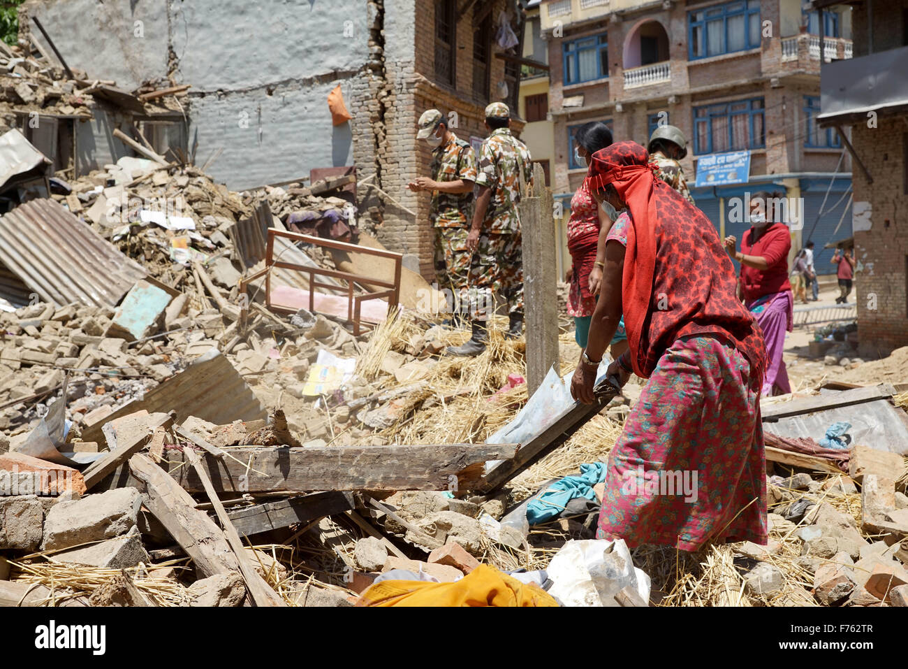 Residents try to retrieve belongings rubble, earthquake, nepal, asia Stock Photo