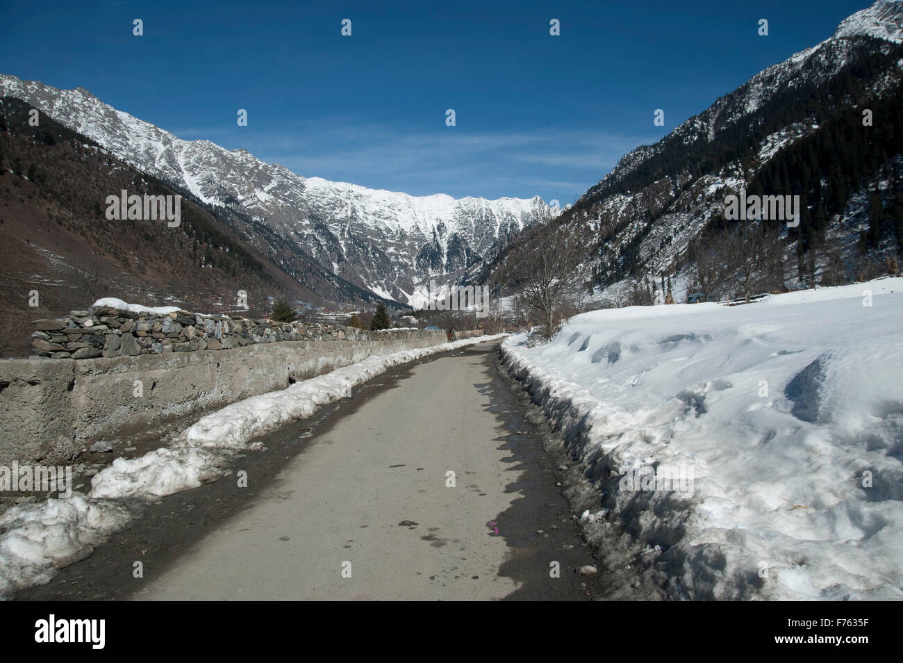 View of snow clad mountains with snow on either side of road Sonmarg Kashmir India Asia Stock Photo