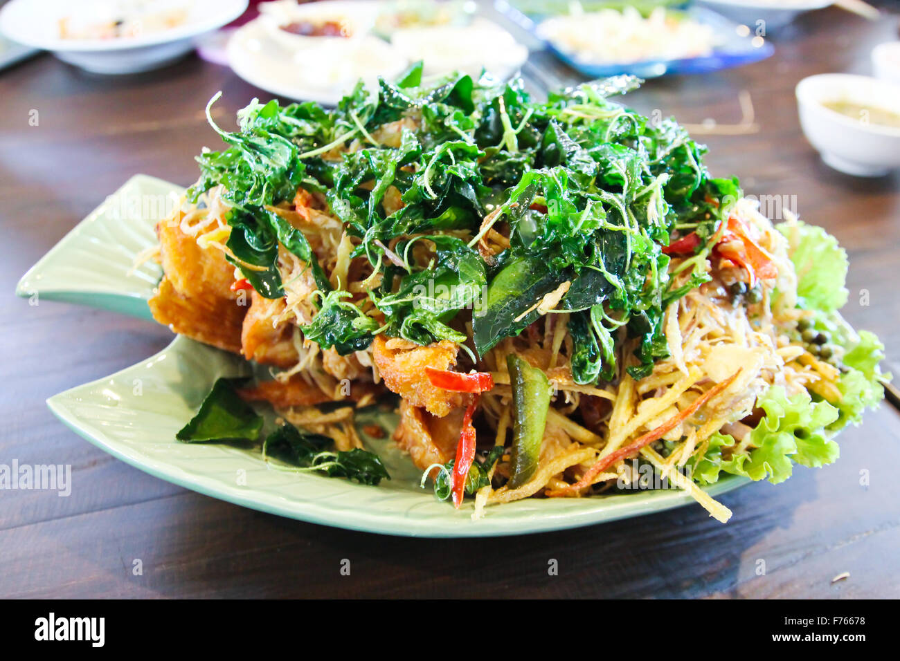 Deep fried fish with herb and spicy sauce, thai food Stock Photo Alamy