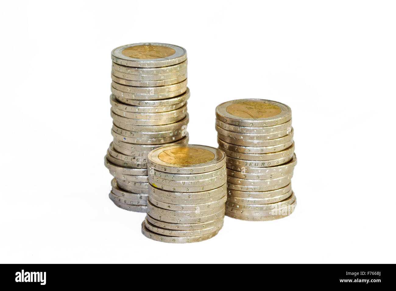 Three piles of two-euro coins, isolated on white Stock Photo
