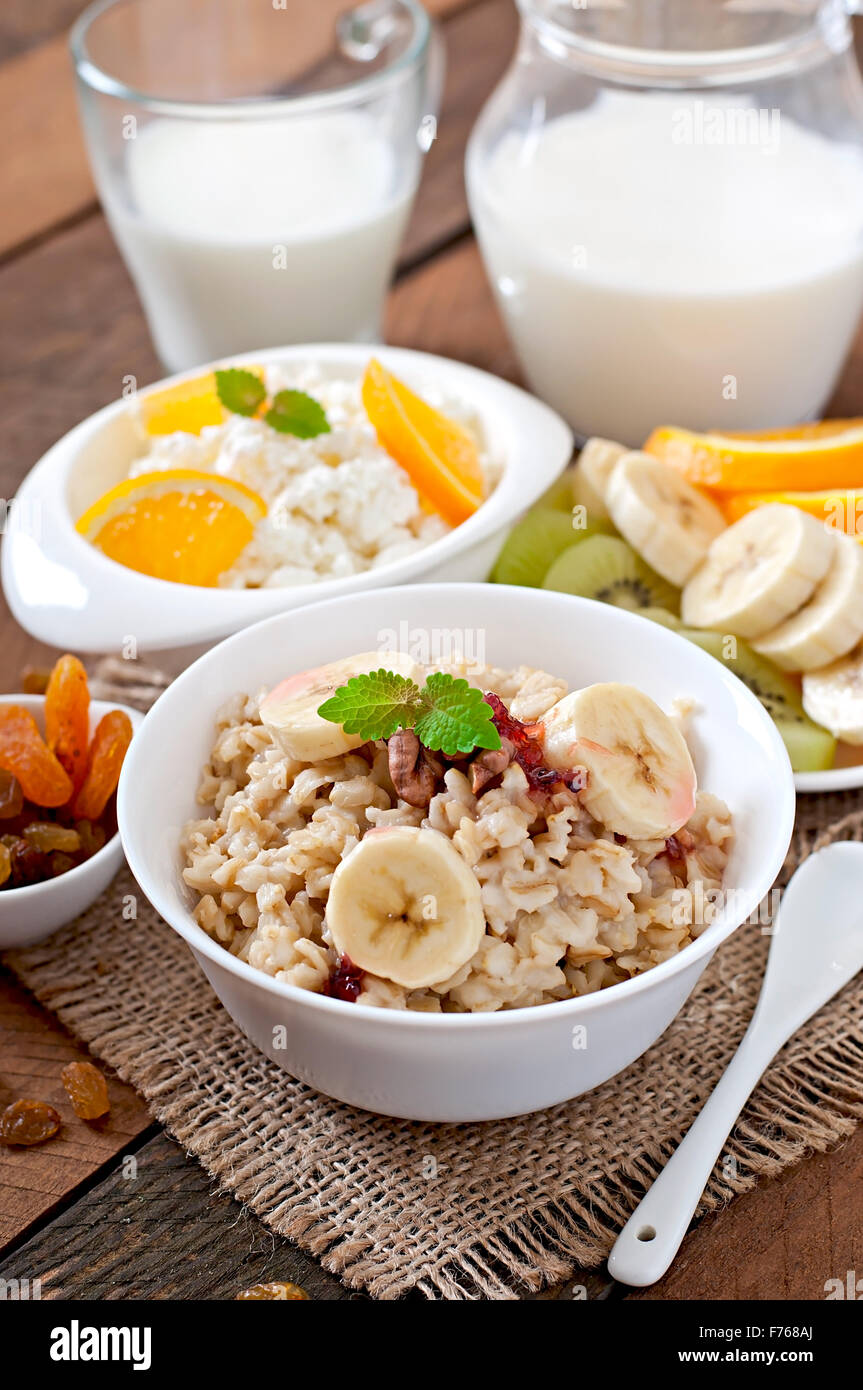 Healthy breakfast oatmeal, cottage cheese, milk and fruit Stock Photo