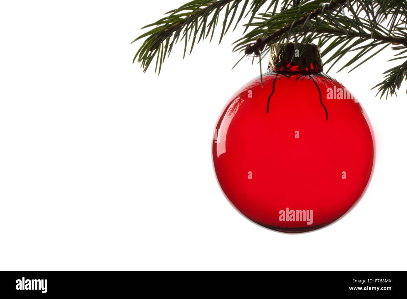 red christmas tree ball hanging from spruce leaf Stock Photo - Alamy