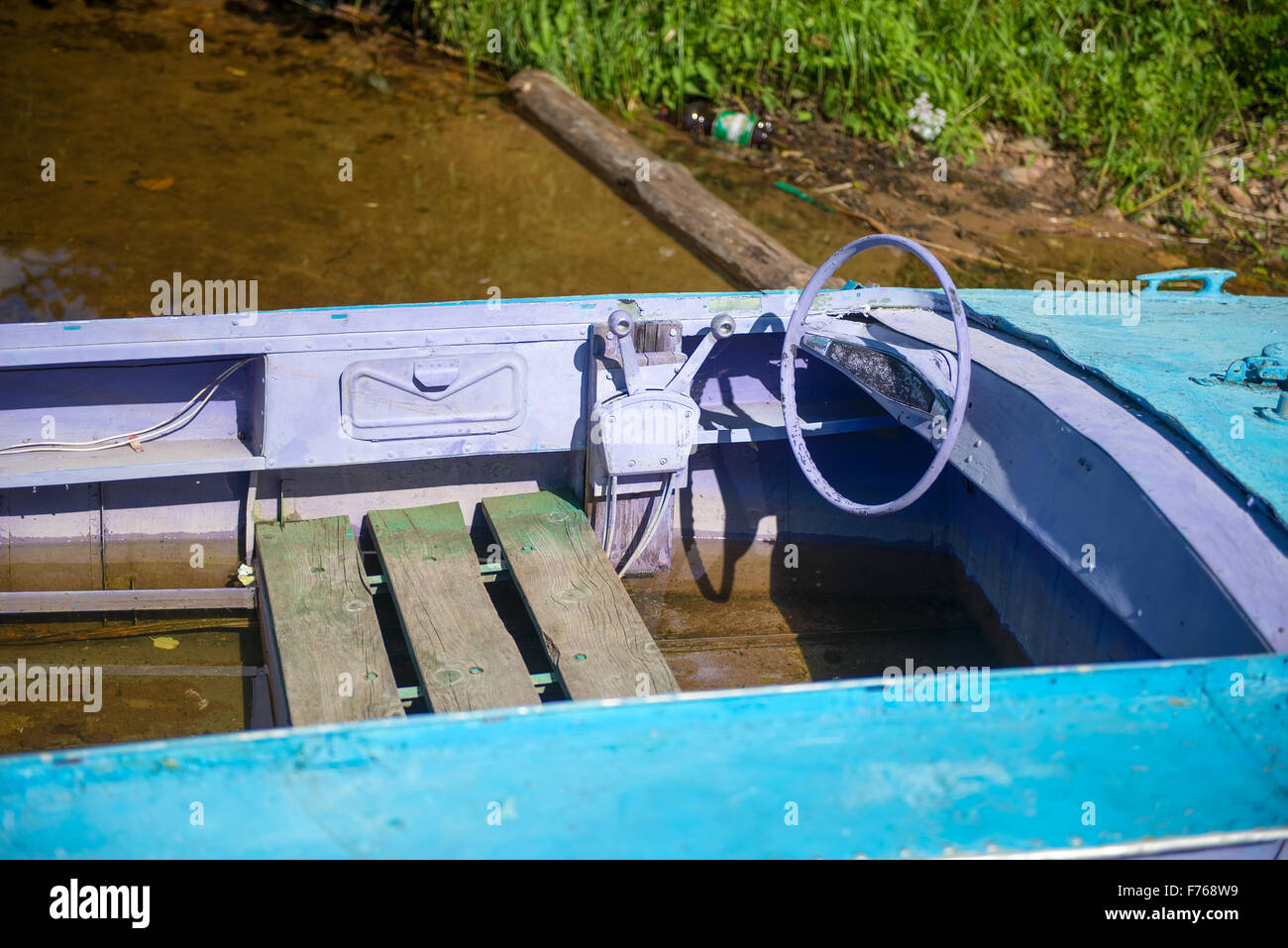 Old motor boat tied to a wooden pier on the lake Stock Photo - Alamy