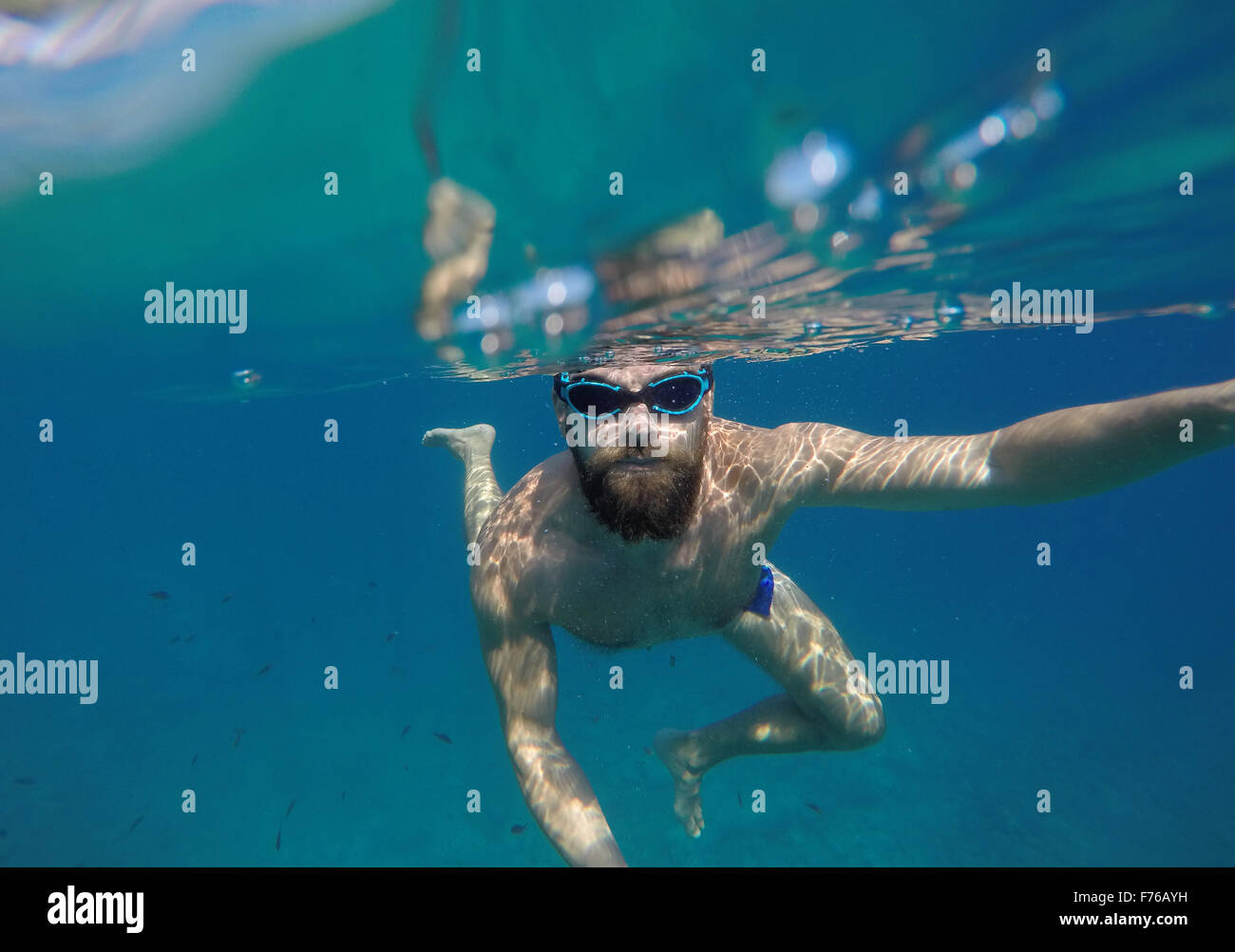 Young beard man with mask diving in a blue clean water Stock Photo Alamy