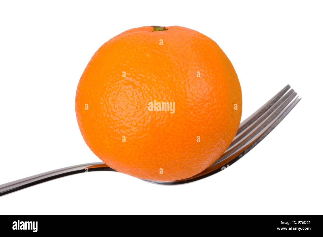 tangerine on a fork over white background Stock Photo Alamy