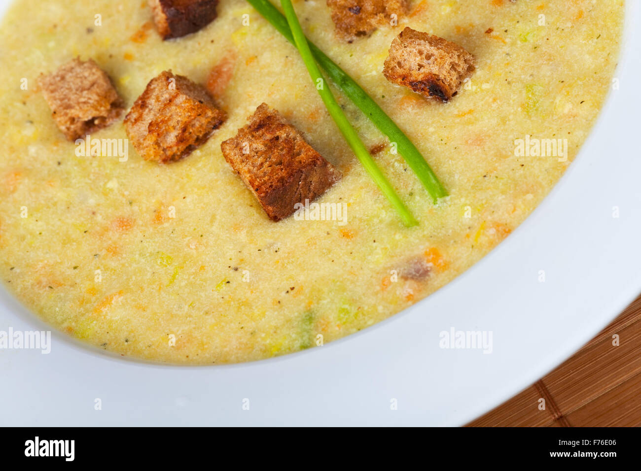 potato soup with croutons and chive strands Stock Photo