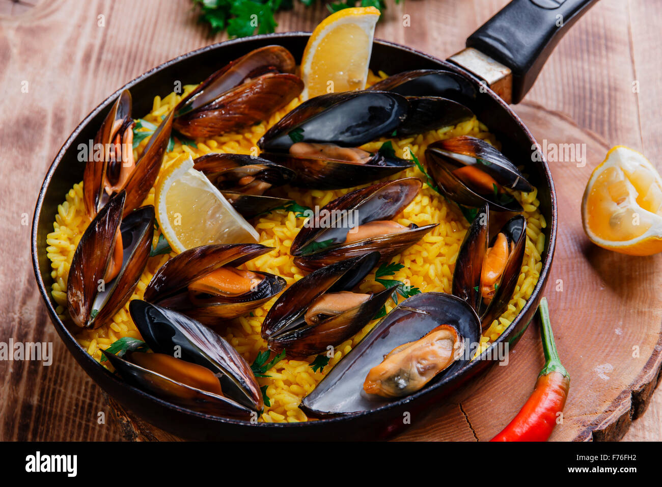 mussel paella rice in a frying pan Stock Photo