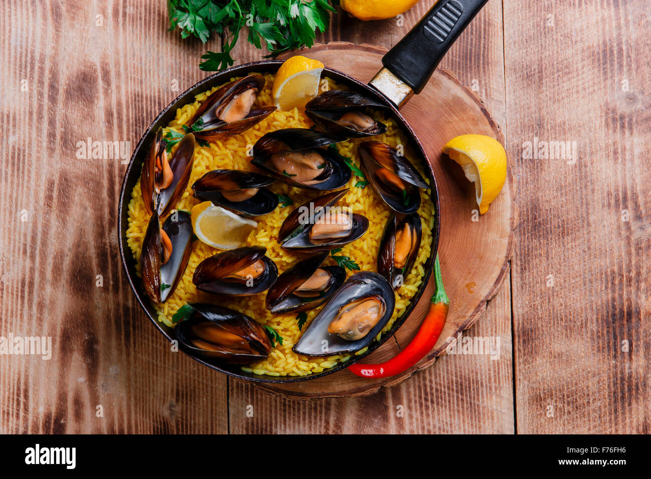 mussel paella rice in a frying pan Stock Photo