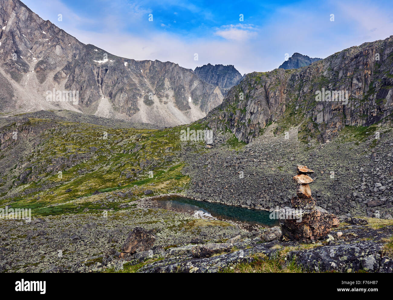 Cairn indicating the hiking trails in the mountain tundra. Eastern Siberia. Eastern Sayan Stock Photo