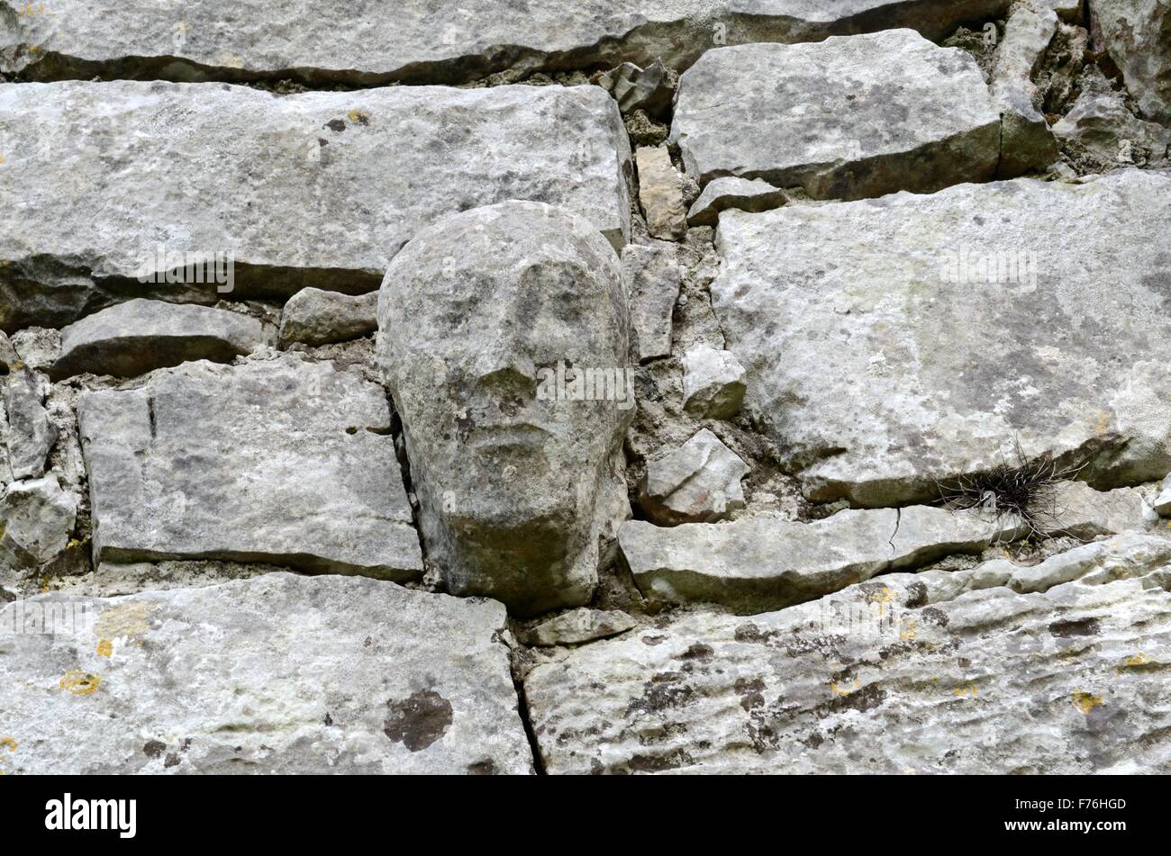 Carved stone capital head on the walls of 12th century Templecronan church Carron The Burren County Clare Ireland Stock Photo