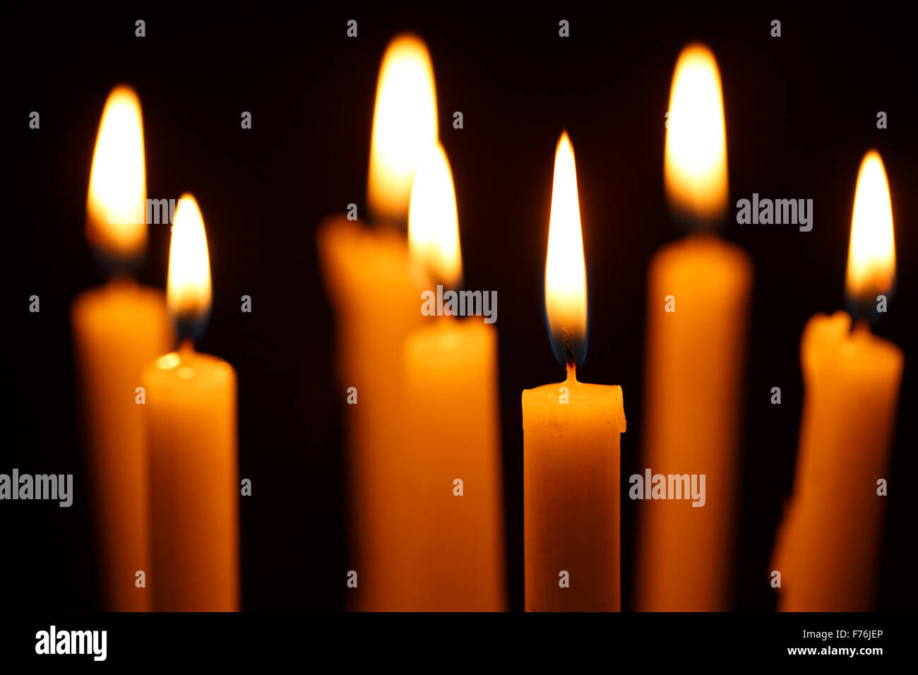 Many burning candles on black background Stock Photo - Alamy
