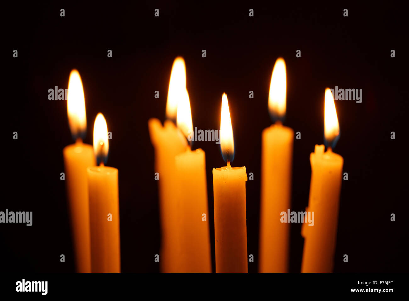 Many burning candles on black background Stock Photo - Alamy