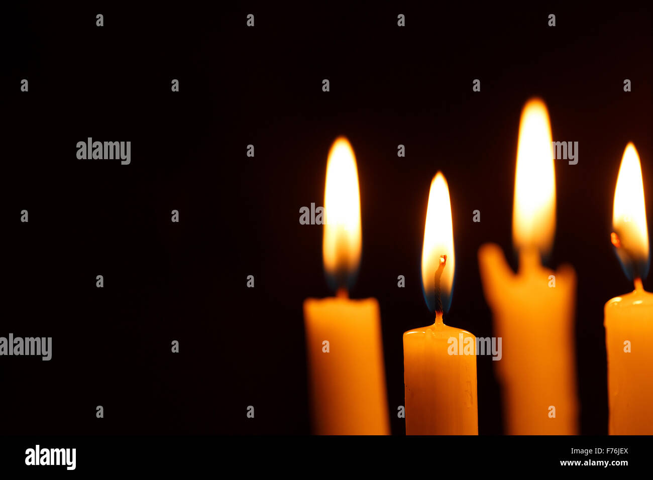Many burning candles on black background Stock Photo - Alamy
