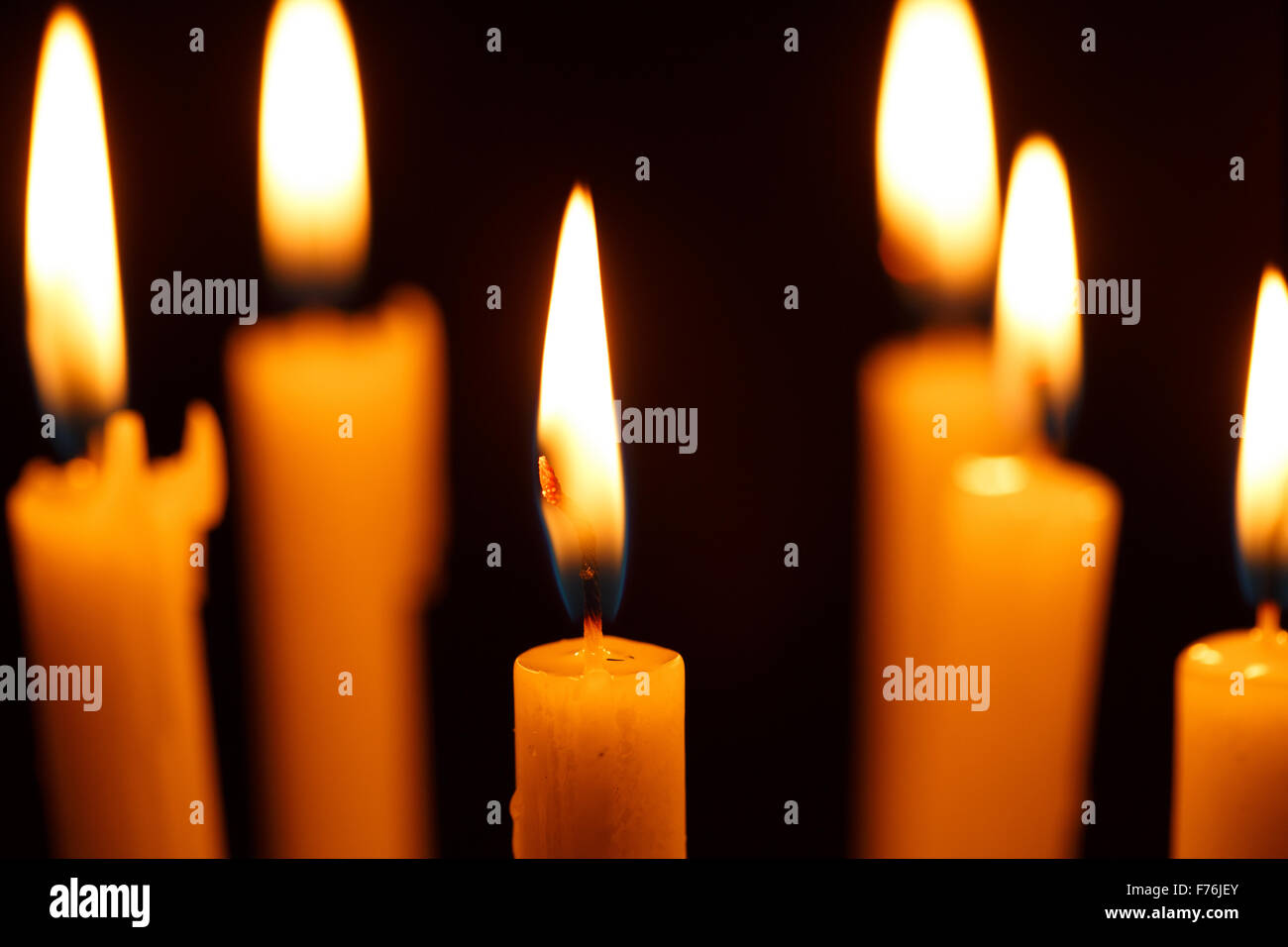 Many burning candles on black background Stock Photo - Alamy