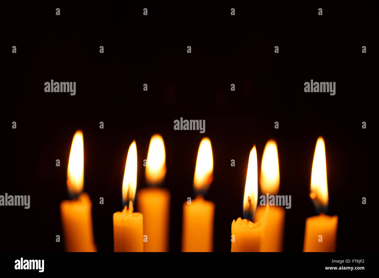 Many burning candles on black background Stock Photo - Alamy
