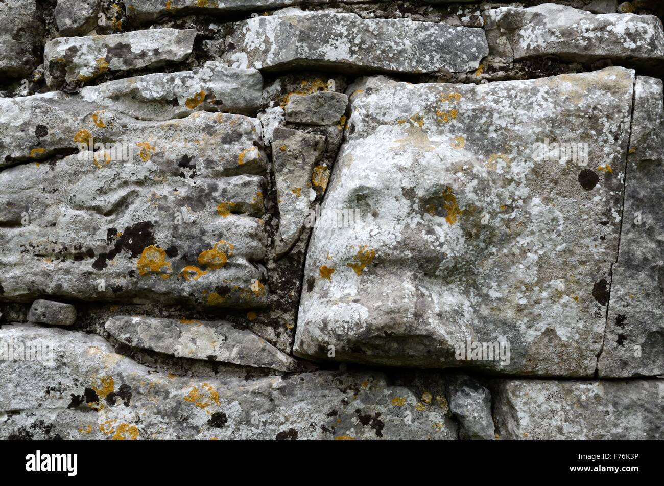 Carved stone capital head on the walls of 12th century Templecronan church Carron The Burren County Clare Ireland Stock Photo